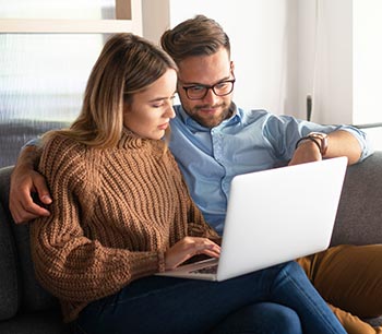 happy couple researching platelet-rich plasma therapy online together